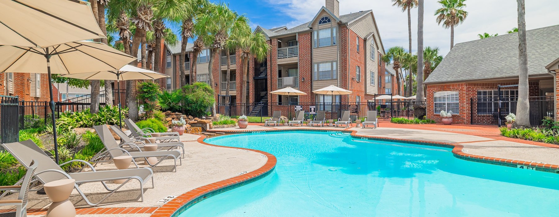 resort style pool with seating and a building behind