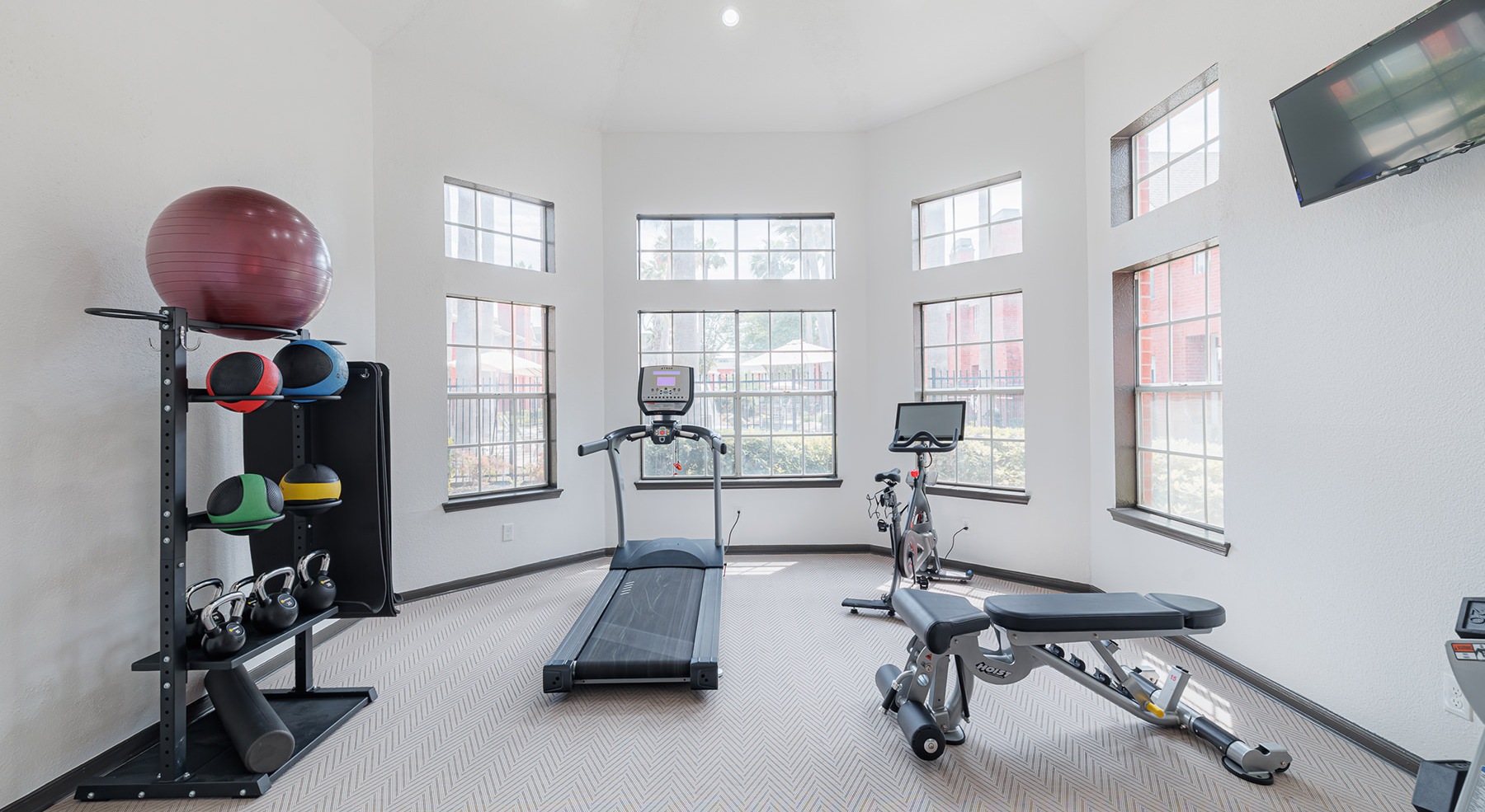 gym with exercise equipment and windows