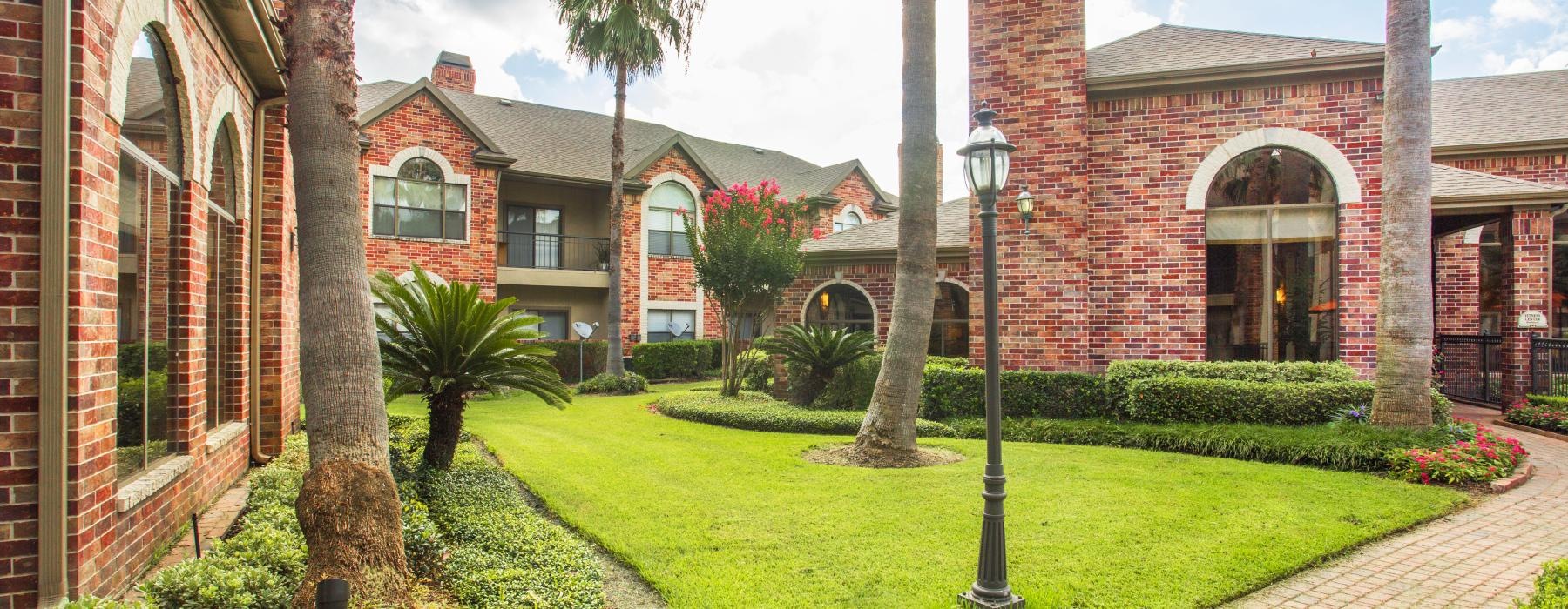 a brick building with palm trees
