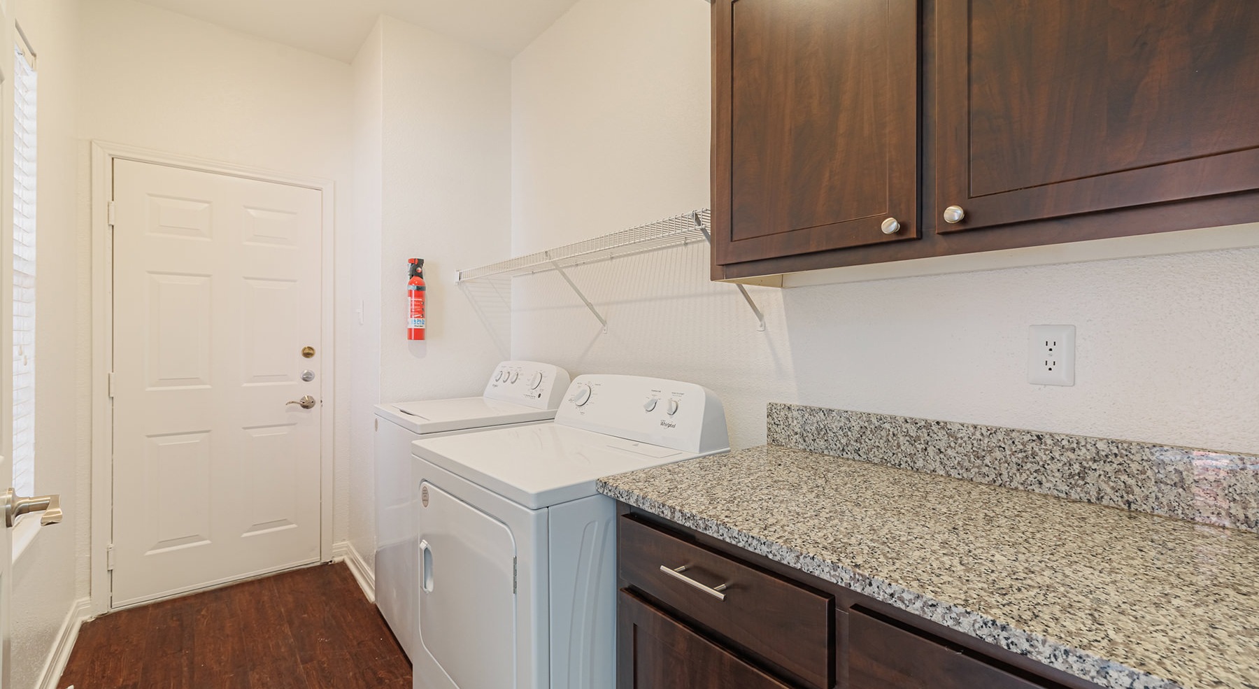 laundry room with washer dryer and wood cabinets 