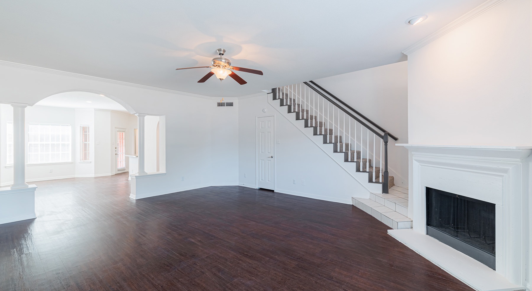living room with hardwood flooring fireplace and stairwell