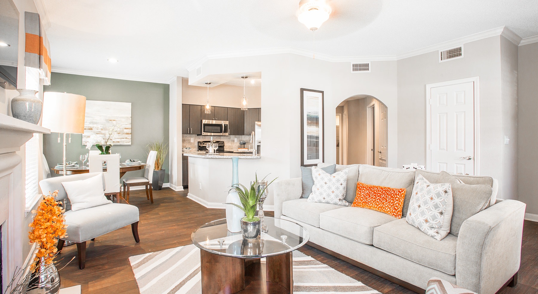 living room with table plant couch and hardwood floors