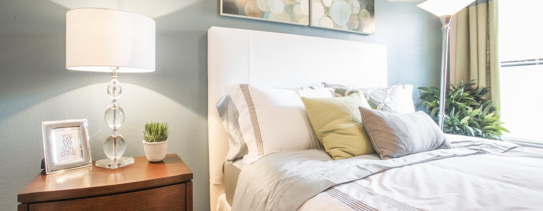 a bed with lamps on either side